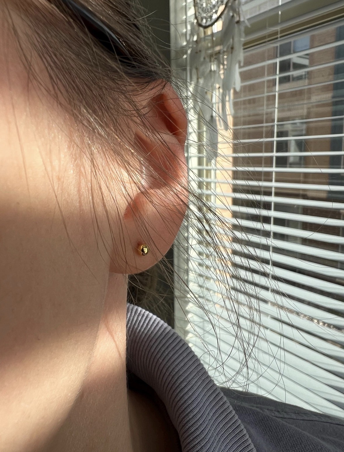 Customer wearing 4mm 24K gold ball earrings