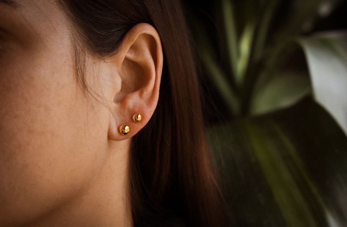 Customer wearing 4mm and 5mm 24K gold ball earrings